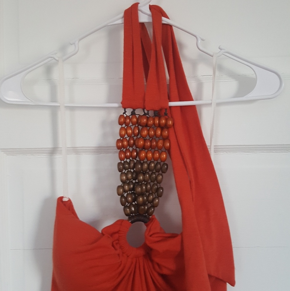 red-orange halter top maxi dress with wooden beads